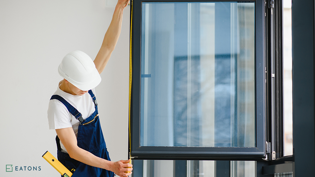 A Man Measuring A Custom Window